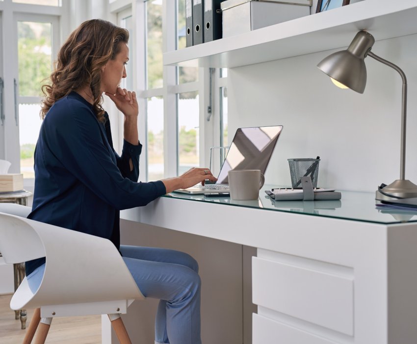 businesswoman entrepreneur working on laptop from home office space